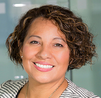 Compliance head Claire Ashford in portrait photograph with financial regulation backdrop